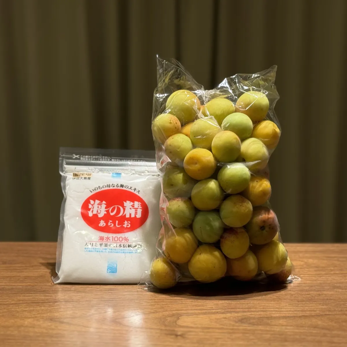 Ume plums beside a bag of Japanese coarse sea salt